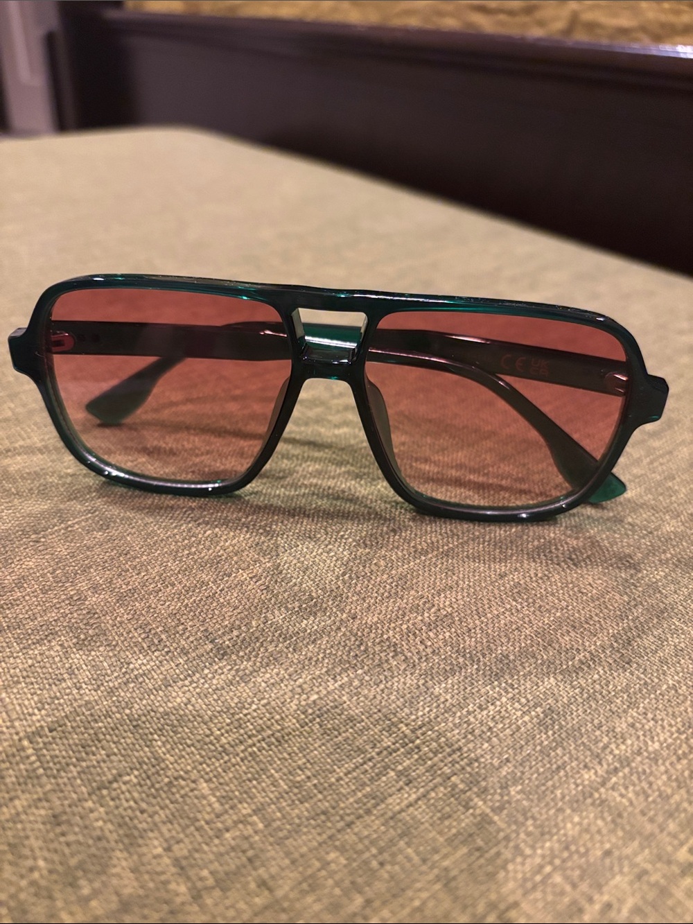 Square framed green rimmed glasses light brown/pink lenses